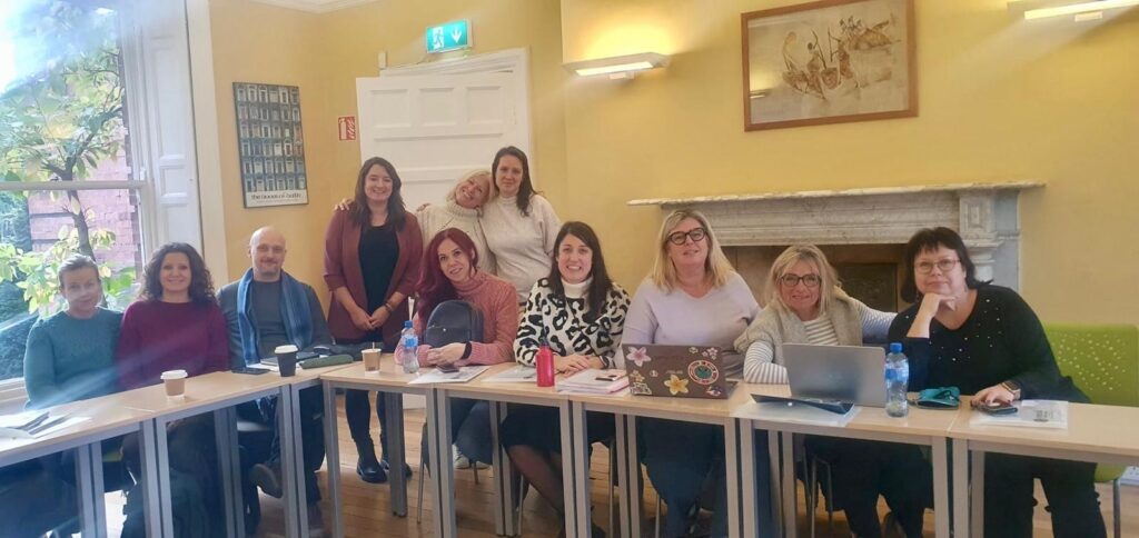 Teacher supporting learners during a class at Emerald Cultural Institute Dublin